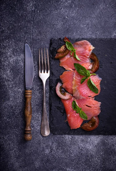 Salmon carpaccio with basil and tomato — Stock Photo, Image