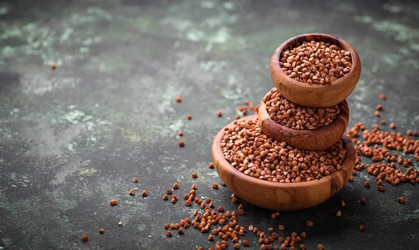 Buckwheat groats in wooden bowl — Stock Photo, Image