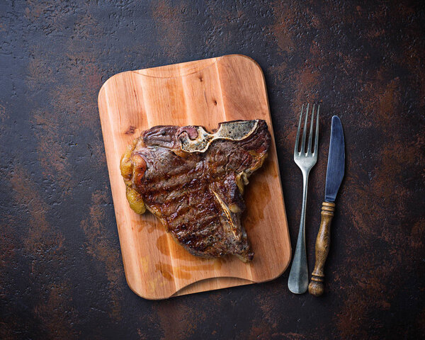 Grilled T-bone steak on dark background