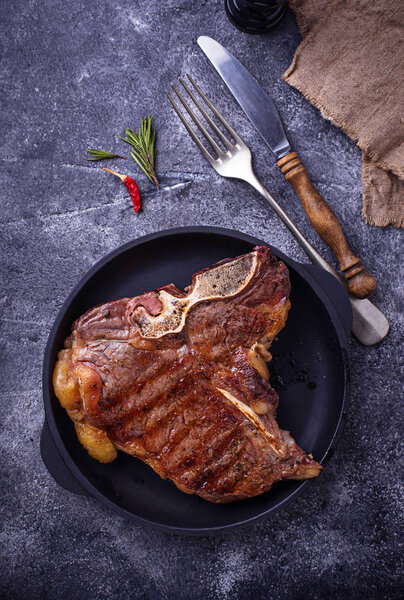 Grilled T-bone steak on dark background