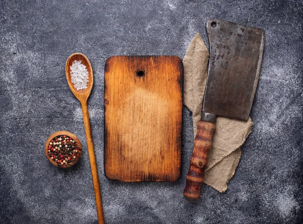 Culinary background with spices, cutting board and hatchet — Stock Photo, Image