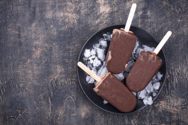Chocolate ice cream popsicles in glaze