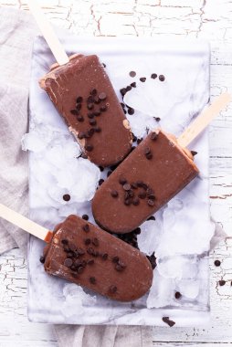Chocolate ice cream popsicles in glaze