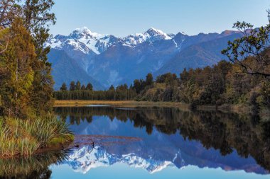 Twin Peaks reflect in the beautiful Lake Matheson, Southern Alps, South Island, New Zealand clipart