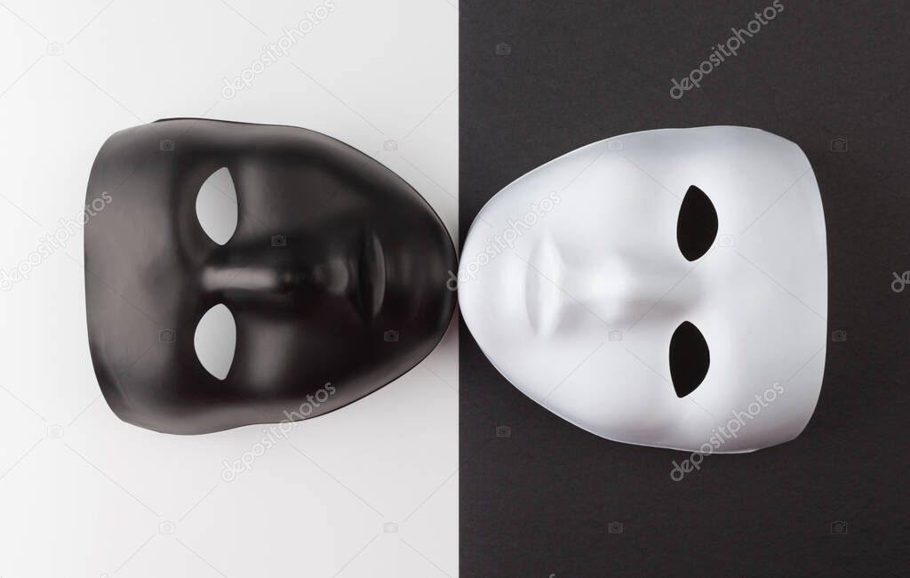 Black and white masks touching chins on contrasting backgrounds, Personality change theatrical concept
