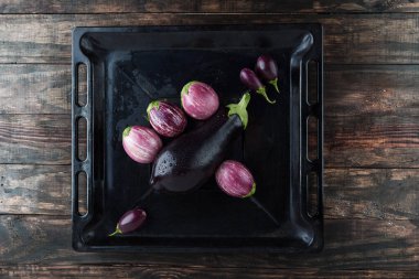 Islak patlıcan - kara büyü, bebeğim, ve kırsal pişirme tepsisinde mor çizgili patlıcan. Kopyalama alanı olan üst görünüm