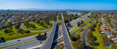 Düz yol kavşaktan geçer ve uzaktaki dağlara çıkar. Melbourne, Avustralya 'da hava manzarası