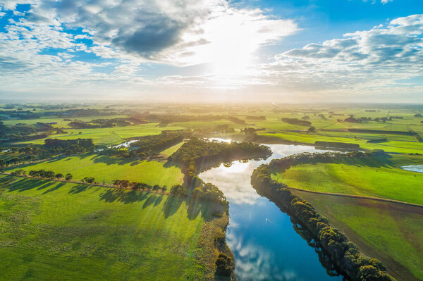 Sunset over river in rural area - aerial view