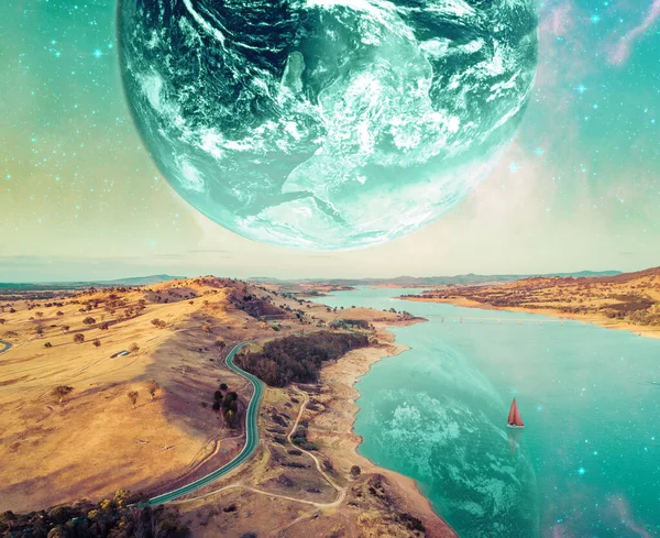 Unreal fantasy landscape of sailboat sailing across a river on alien planet. Elements of this image furnished by NASA