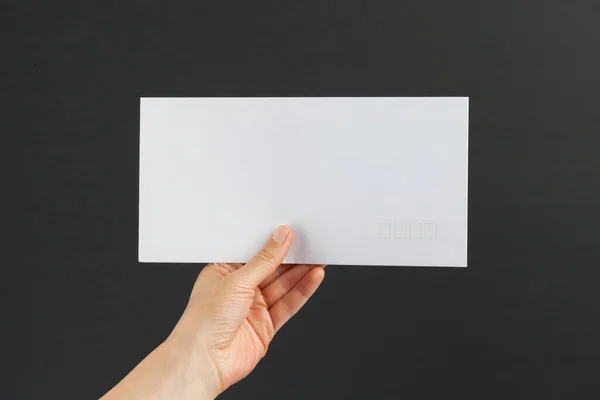 Female Hand Delivering White Postage Envelope Black Background — Stock Photo, Image