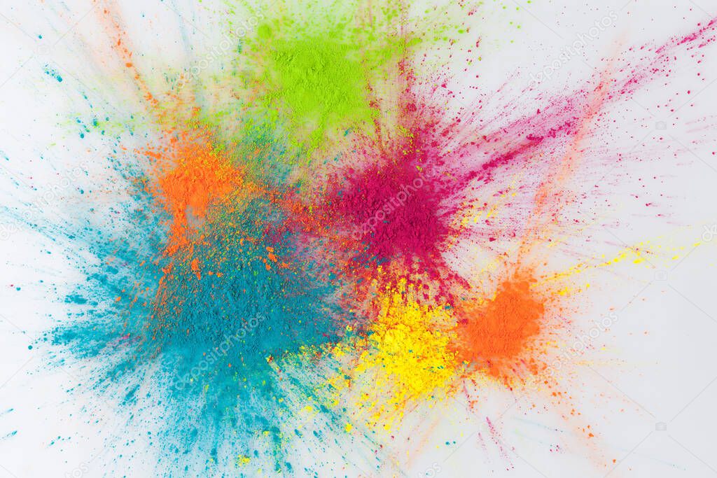 Color explosion concept. Colorful Holi powder exploding on white background