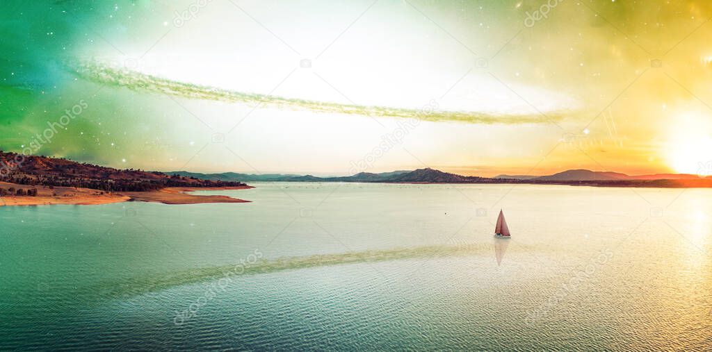 Scenic unreal sunset over beautiful lake and lonely sailboat on alien planet. Elements of this image furnished by NASA