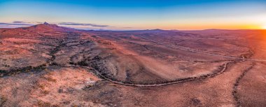 Aerial panoramic landscape of sunset sun flare over alien landscape of Flinders Ranges in South Australia clipart