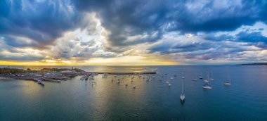 Mornington İskelesi 'nin hava panoraması ve güzel, canlı günbatımı ve bulutlu manzarada demirli yatlar. Melbourne, Victoria, Avustralya