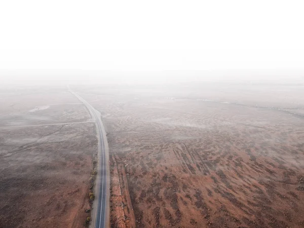 Aerial View Road Passing Red Desert Land Disappearing White Fog — Stock Photo, Image