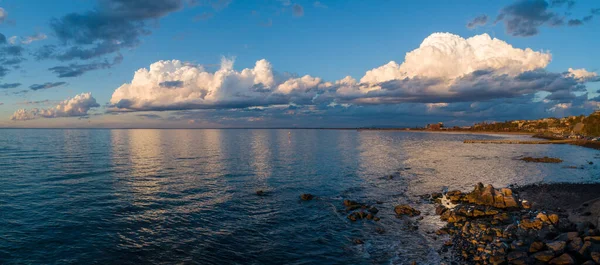 Wide panorama of beautiful clouds over ocean coastline in Frankston, Victoria, Australia