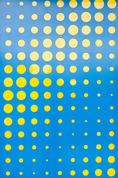 Abstract pattern of yellow circles in various sizes on blue background