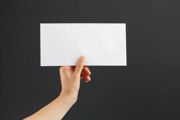 Female Hand Holding White Postage Envelope Black Background — Stock Photo, Image