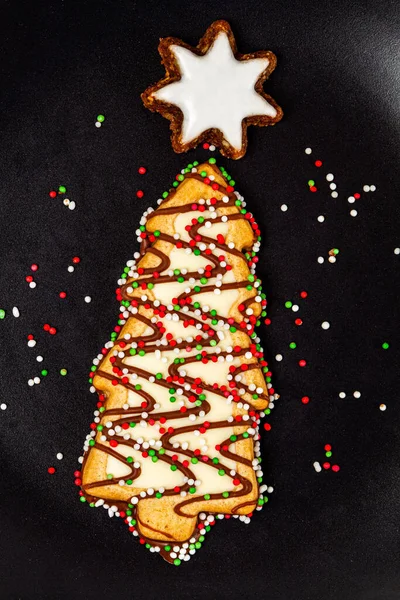 Versierde Kerstboom Biscuit Met Kleurrijke Hagelslag Zwarte Achtergrond — Stockfoto