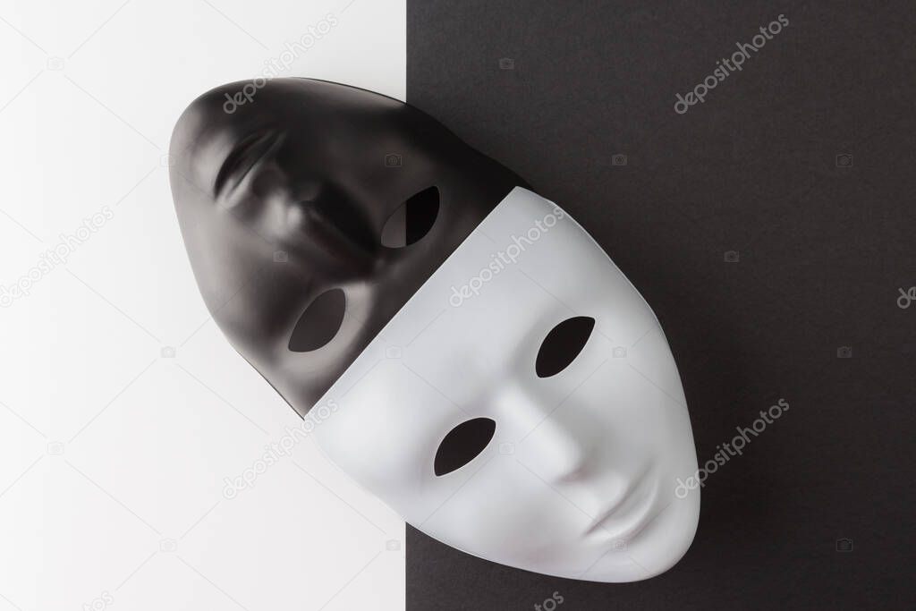 Black and white masks placed diagonally on contrasting background. Web anonymity concept