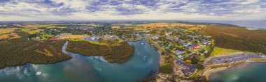 Aerial panorama of small coastal town near ocean coastline in, Victoria, Australia clipart