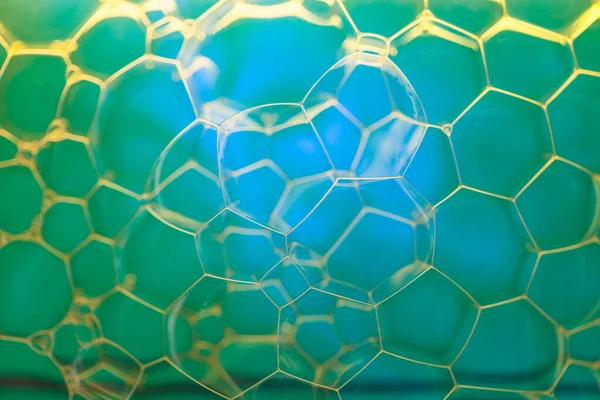 stock image Soap suds extreme closeup creating honeycomb pattern of golden lines