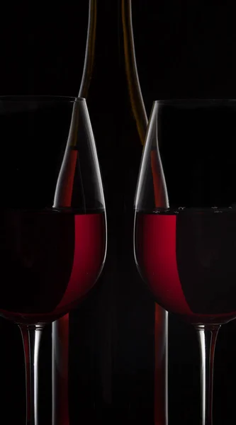 Μπουκάλι Κόκκινο Κρασί Και Δύο Ποτήρια Κρασί Μαύρο Φόντο — Φωτογραφία Αρχείου