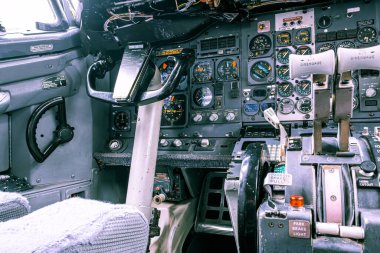 Closeup view of old aircraft cockpit with yoke and knobs clipart