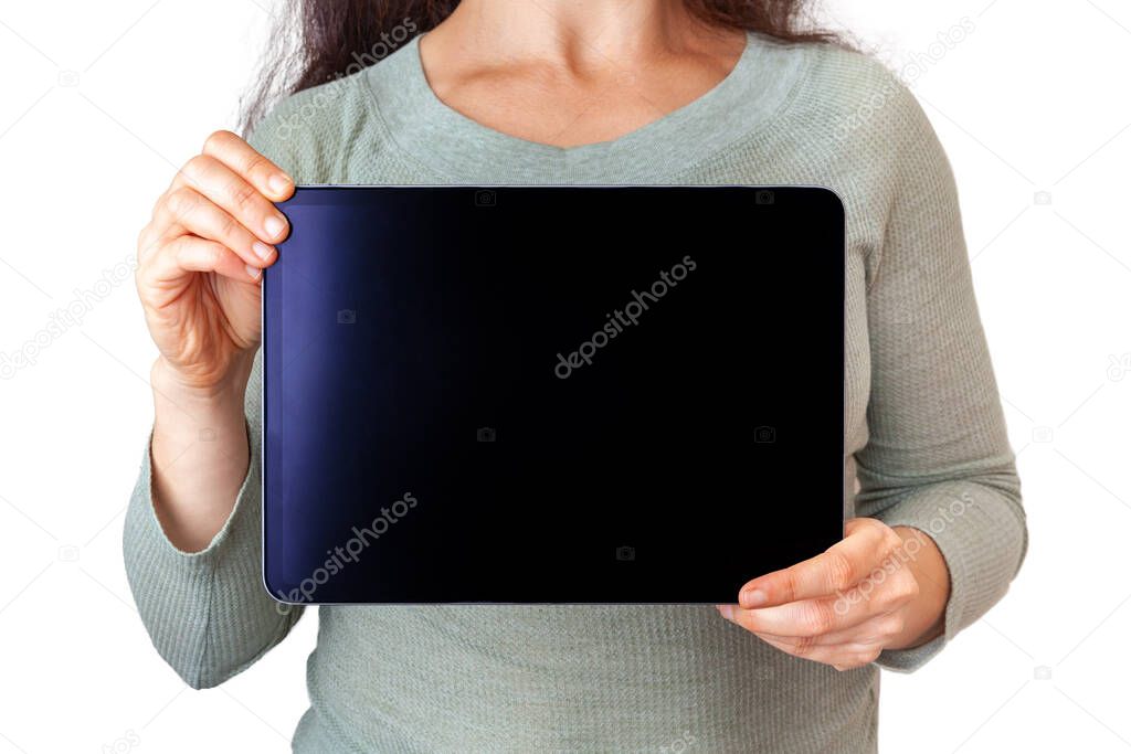 Woman holding tablet in front of her body with copy space