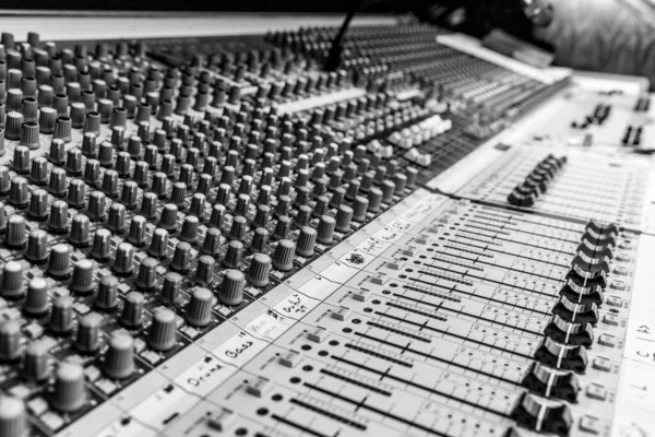 B&W Analog sound mixing console used to mix music and microphones