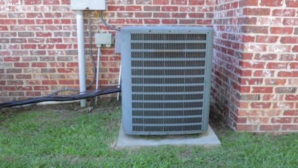 Dolly shot of air conditioner units next to brick home — Stock Video