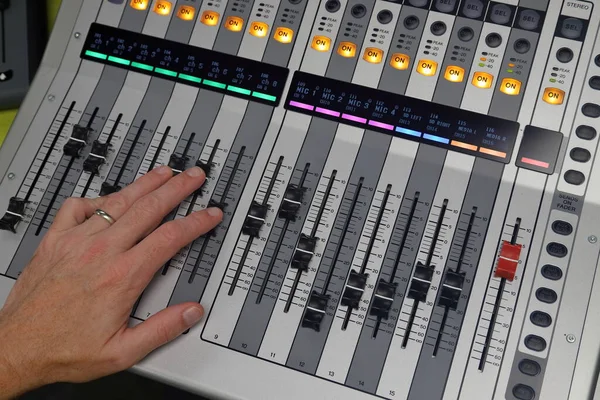 Hand mixing audio on Digital Sound mixing console