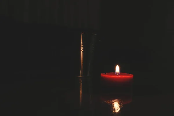 red candle with plant