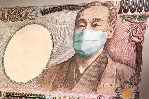 Japonya 'daki koronavirüs salgınının tıbbi maskesiyle birlikte 10,000 yen' lik banknotlar. Koronavirüs salgınının Japonya ekonomisi üzerindeki etkisi. Koronavirüsün para birimi üzerindeki etkisi.