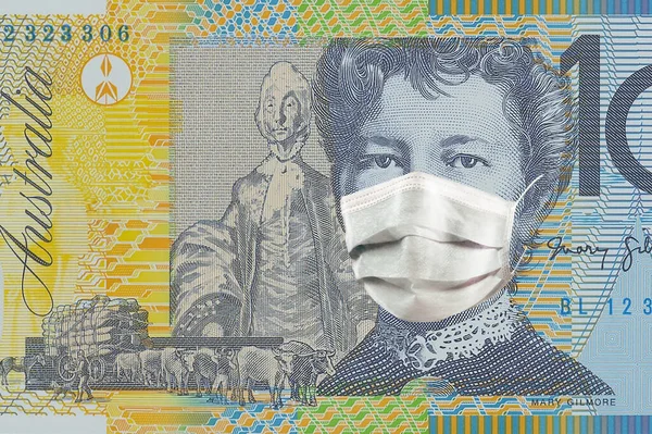 10 Australian dollars in a medical mask. Coronavirus epidemic in Australia .Impact of the coronavirus epidemic on the Australian economy