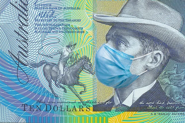 Tıbbi bir maskenin içinde 10 Avustralya doları. Avustralya 'da koronavirüs salgını. Coronavirüs salgınının Avustralya ekonomisine etkisi.