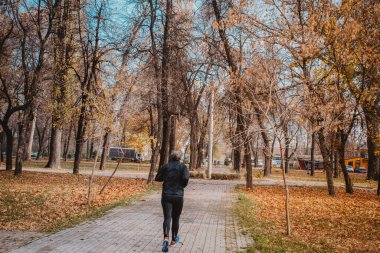 Bitola / North Macedonia - 03.15.2020: Mature woman  jogging and trying to stay healthy in quarantine time because of covid-19, corona virus clipart