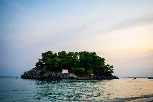 Güzel gün batımı ve deniz arka planında bir ada