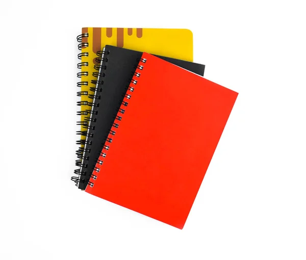 三本红黑黄相间的纸记事本 放在白底上 — 图库照片