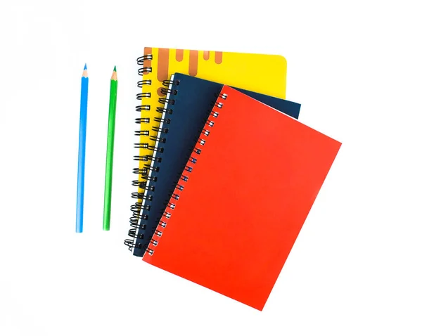 蓝色和绿色的木制铅笔蜡笔 放在三本不同颜色的笔记本旁边 白色背景 — 图库照片