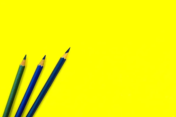 Three Dark Blue Colored Wood Pencil Crayon Placed Top Yellow — Stock Photo, Image