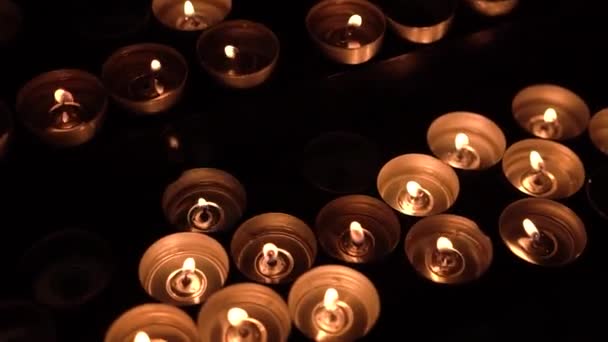 Many Small Candles Burn Dark Room — Stock Video