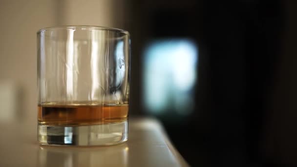 Man Walks Glass Whiskey Stands Table Takes His Hand Close — Stock Video