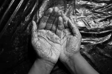 Kara arka planda Clay 'in elleri lekeli.