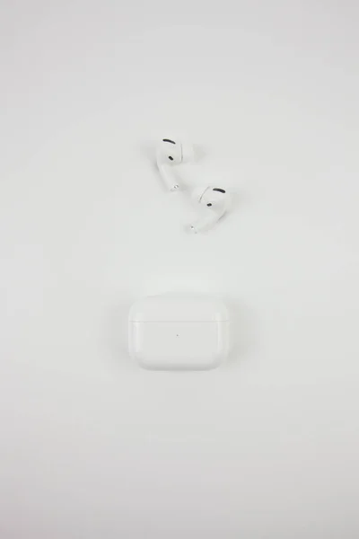 Wireless white earphones on a white background.