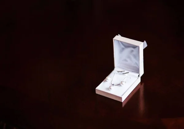 Earrings. Earrings lying in box on table background.