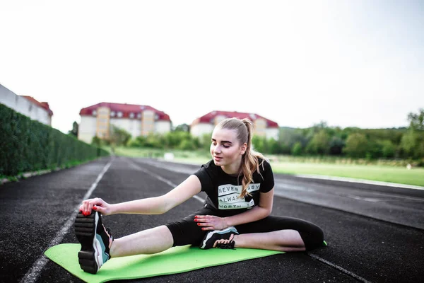 健康的运动生活方式 穿着运动服做运动锻炼的年轻女子 体育馆的健身女士 年轻女人在做伸展运动 这个年轻姑娘参加体育活动 伸懒腰 — 图库照片