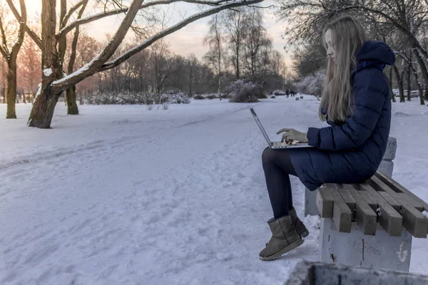 girl working on a computer in nature