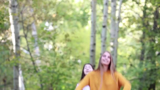 Dvě dívky veselá přítelkyně zvracet modré a červené látky na den přírody — Stock video