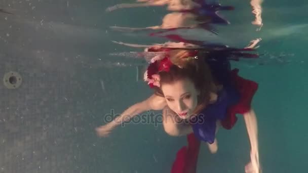 Jonge vrouw onder het water in het zwembad. Fashion stijl — Stockvideo